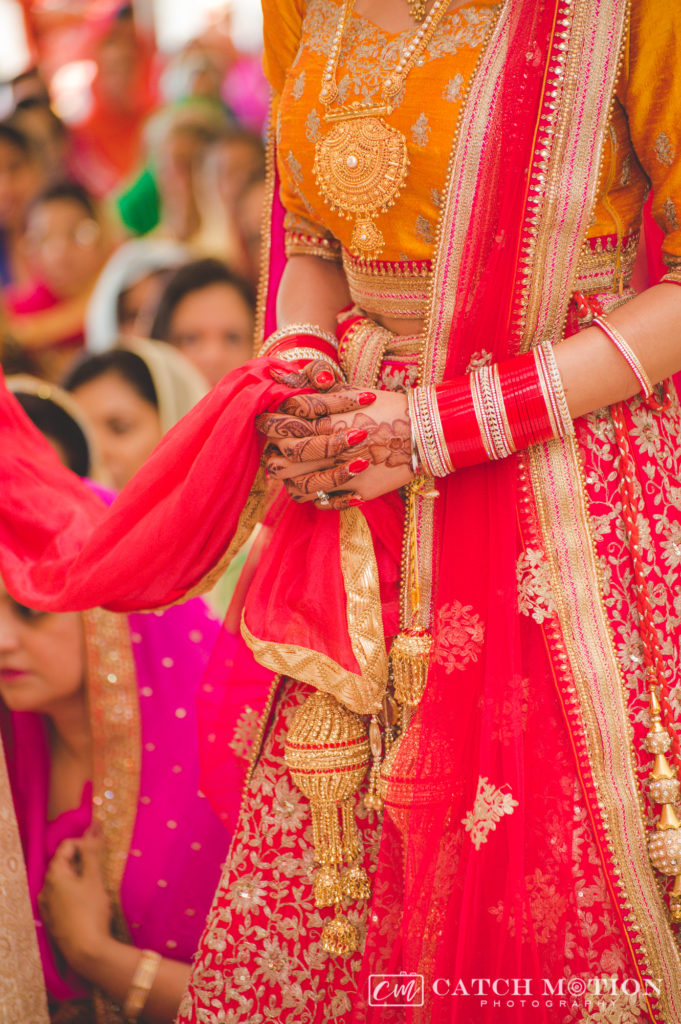 Sikh bride on wedding day holding palla