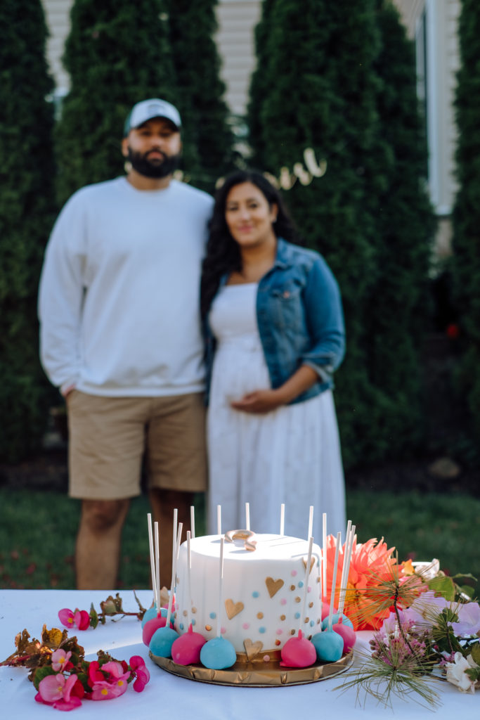 Indian couple pose with gender reveal cake