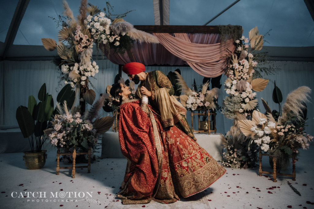 Sikh groom dips his beautiful bride